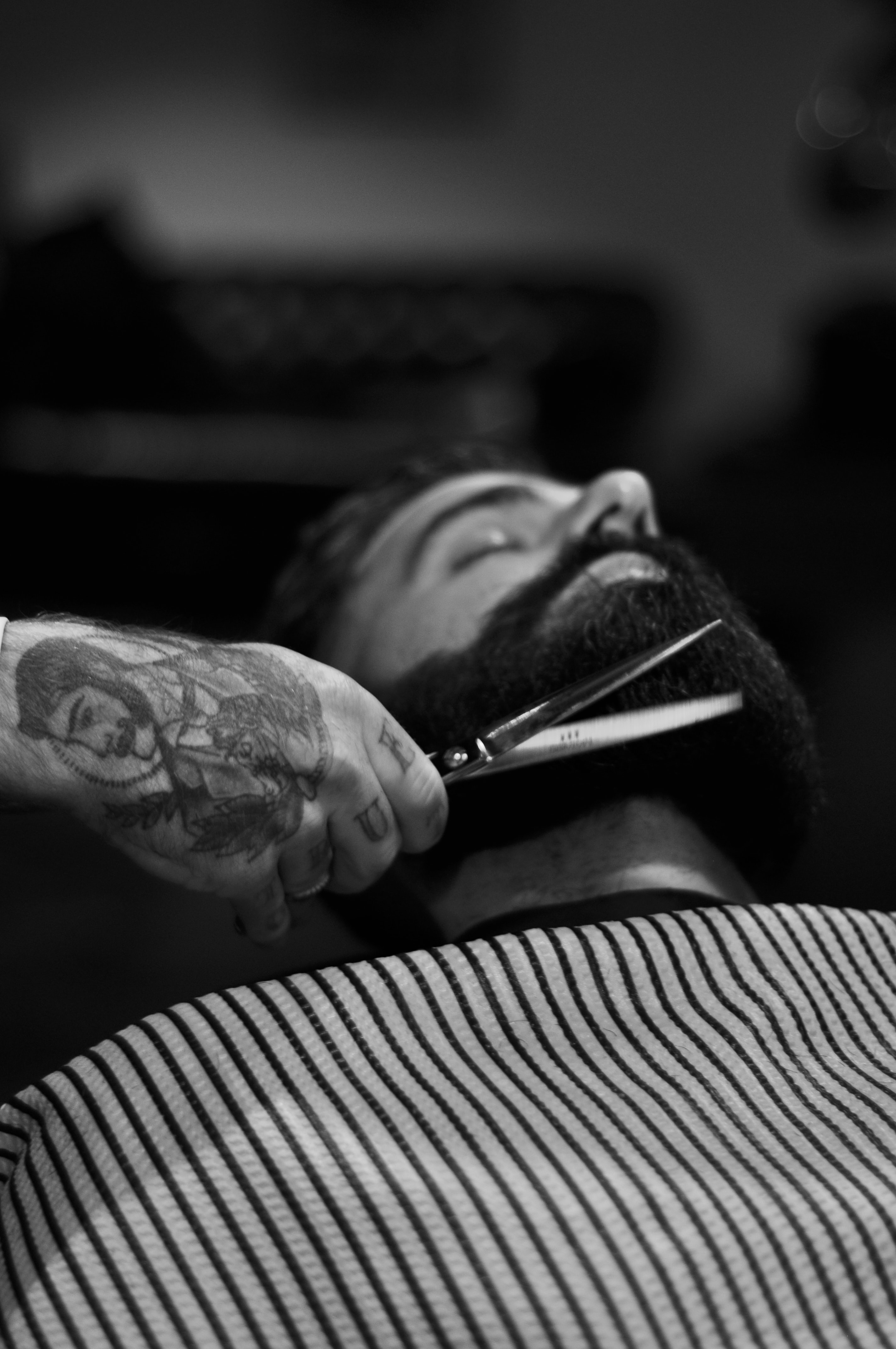 a man getting his beard trimmed